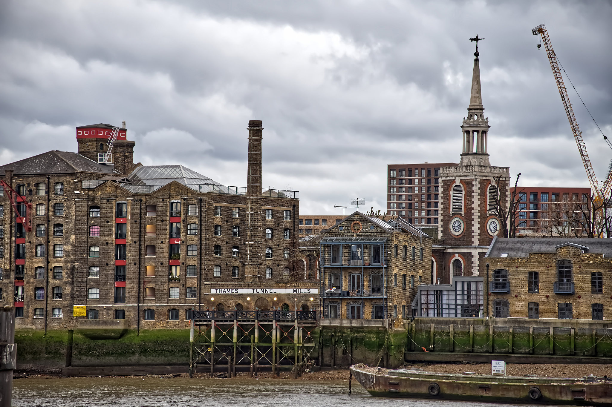 View from Wapping across the Thames to former 19th century warehouses and a flour mill in Rotherhithe